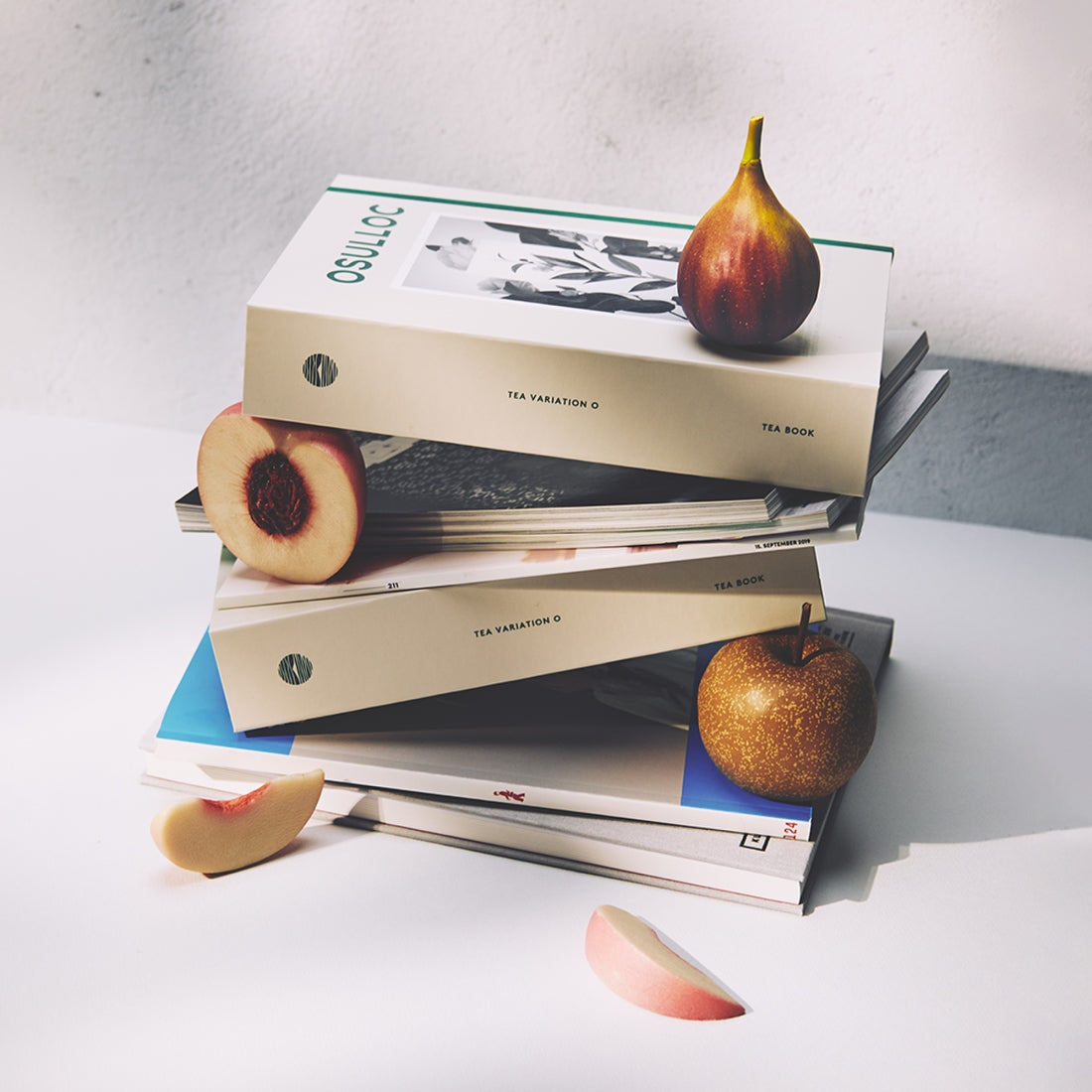 OSULLOC Tea Variation O 6 types boxes stacked with fruits for a visually appealing lifestyle setting.