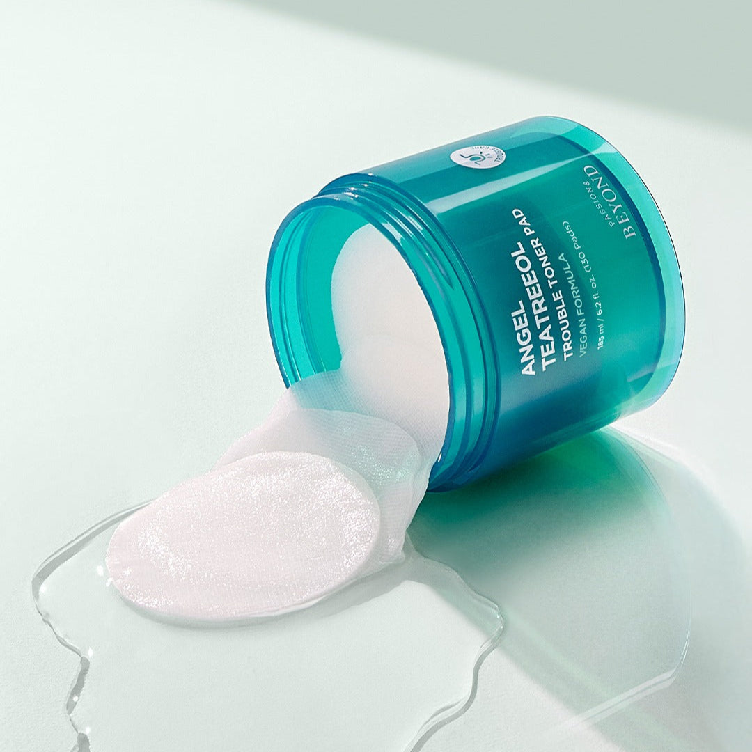 Open jar of PASSION&BEYOND Angel Tea Tree Trouble Toner Pads 185ml with spilling pads on a light surface
