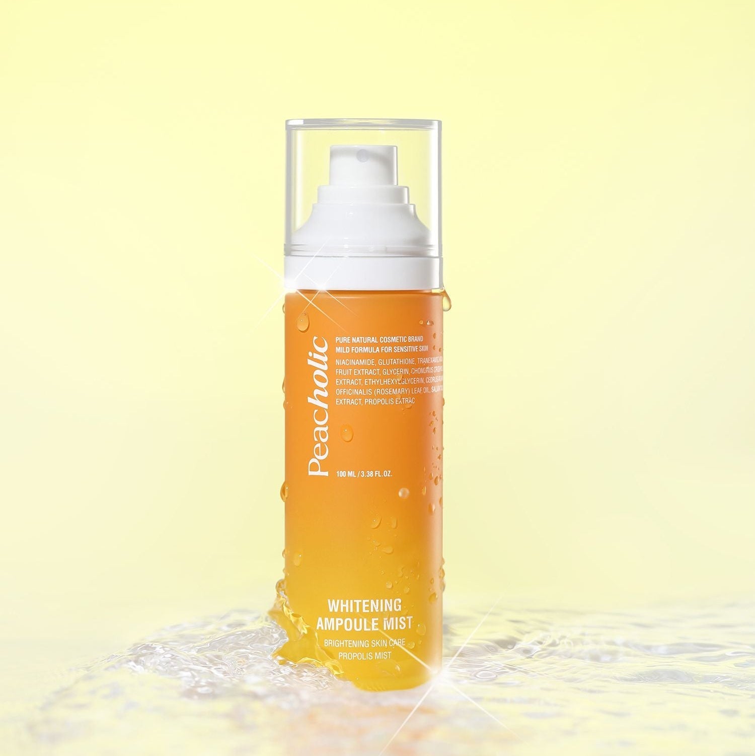 PEACHOLIC Whitening Ampoule Mist 100ml on a reflective surface with a yellow background, showcasing brightening benefits.