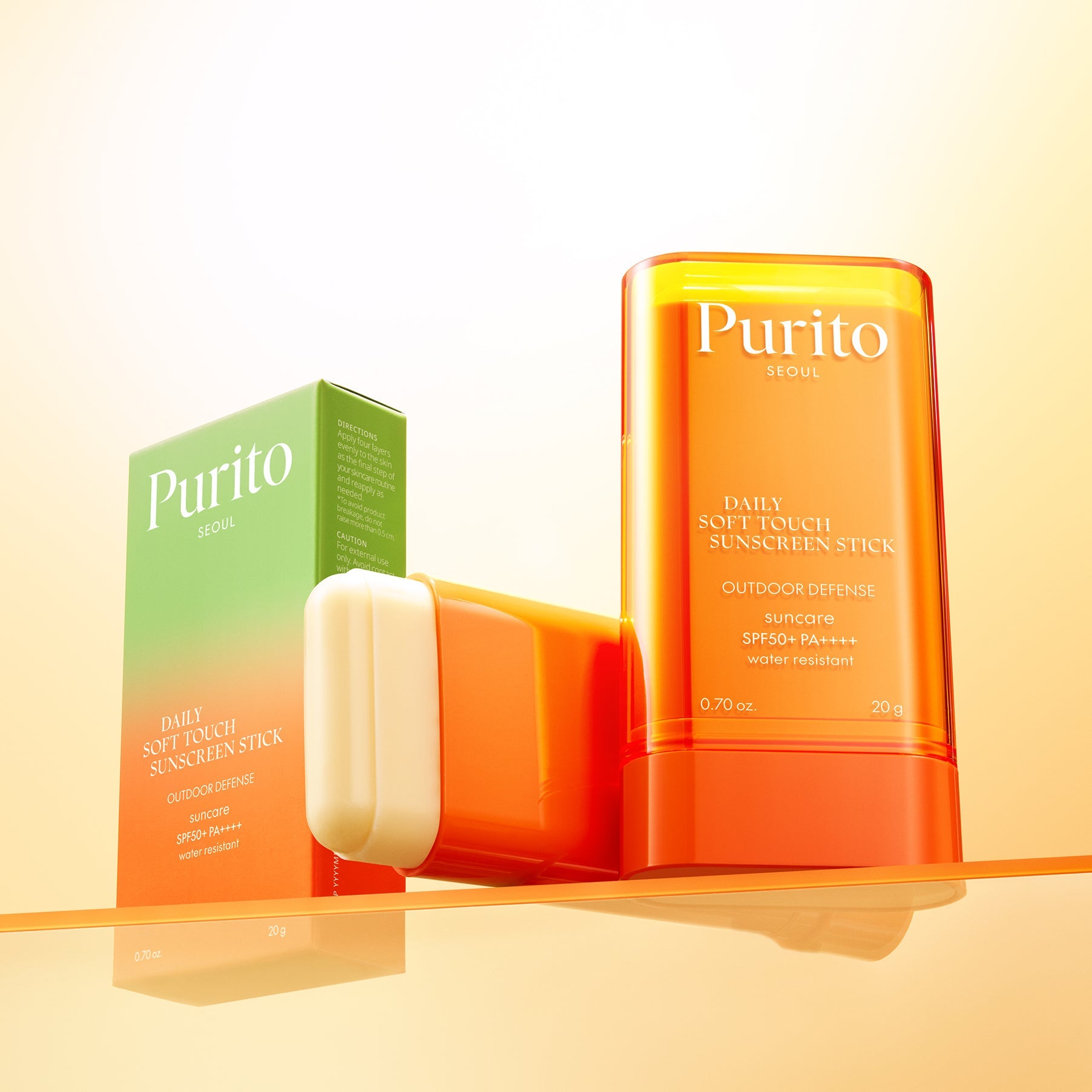 PURITO Daily Soft Touch Sun Stick SPF50+PA++++ displayed with packaging on a reflective surface, highlighting sun protection features.