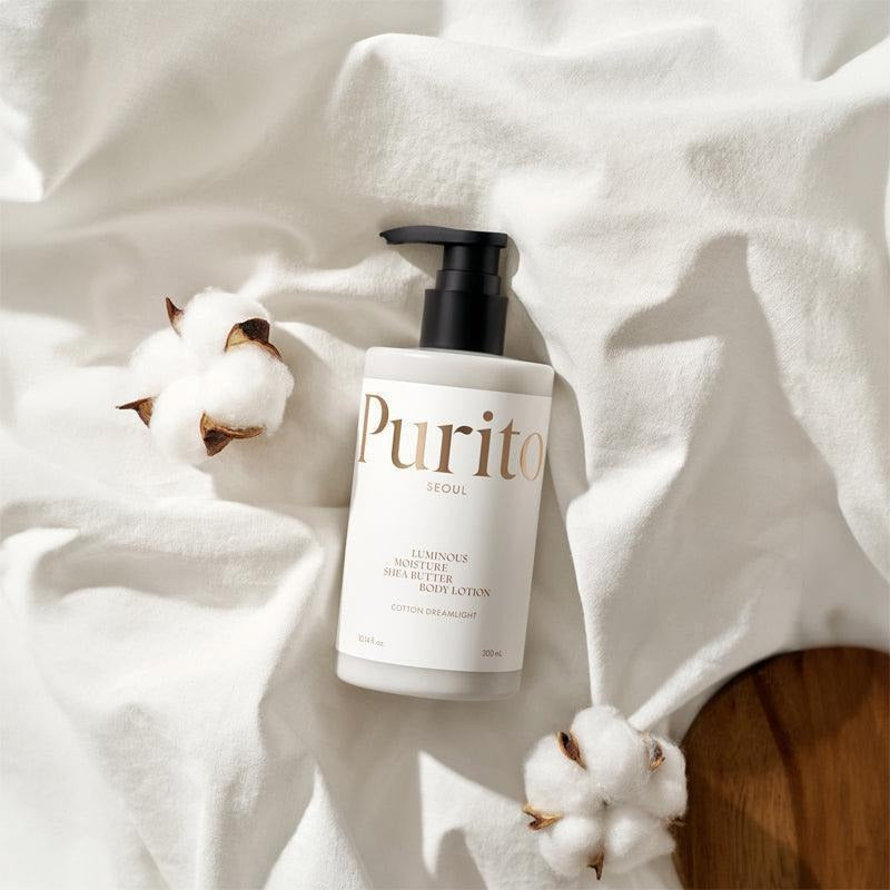 PURITO Luminous Moisture Shea Butter Body Lotion 300ml bottle with cotton flowers on white cloth