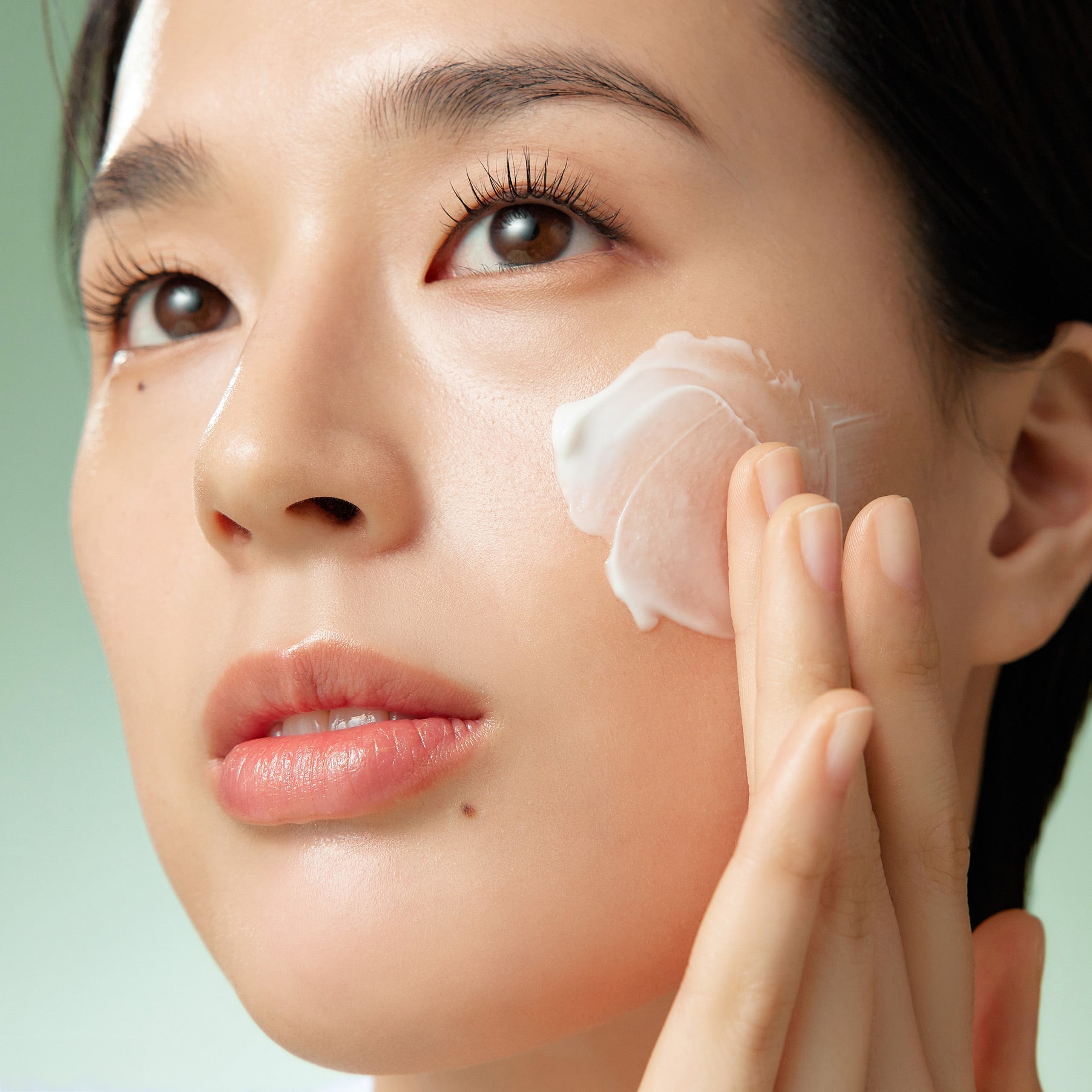 Applying PURITO Wonder Relief Centella Cream Unscented 50ml on face for skincare routine