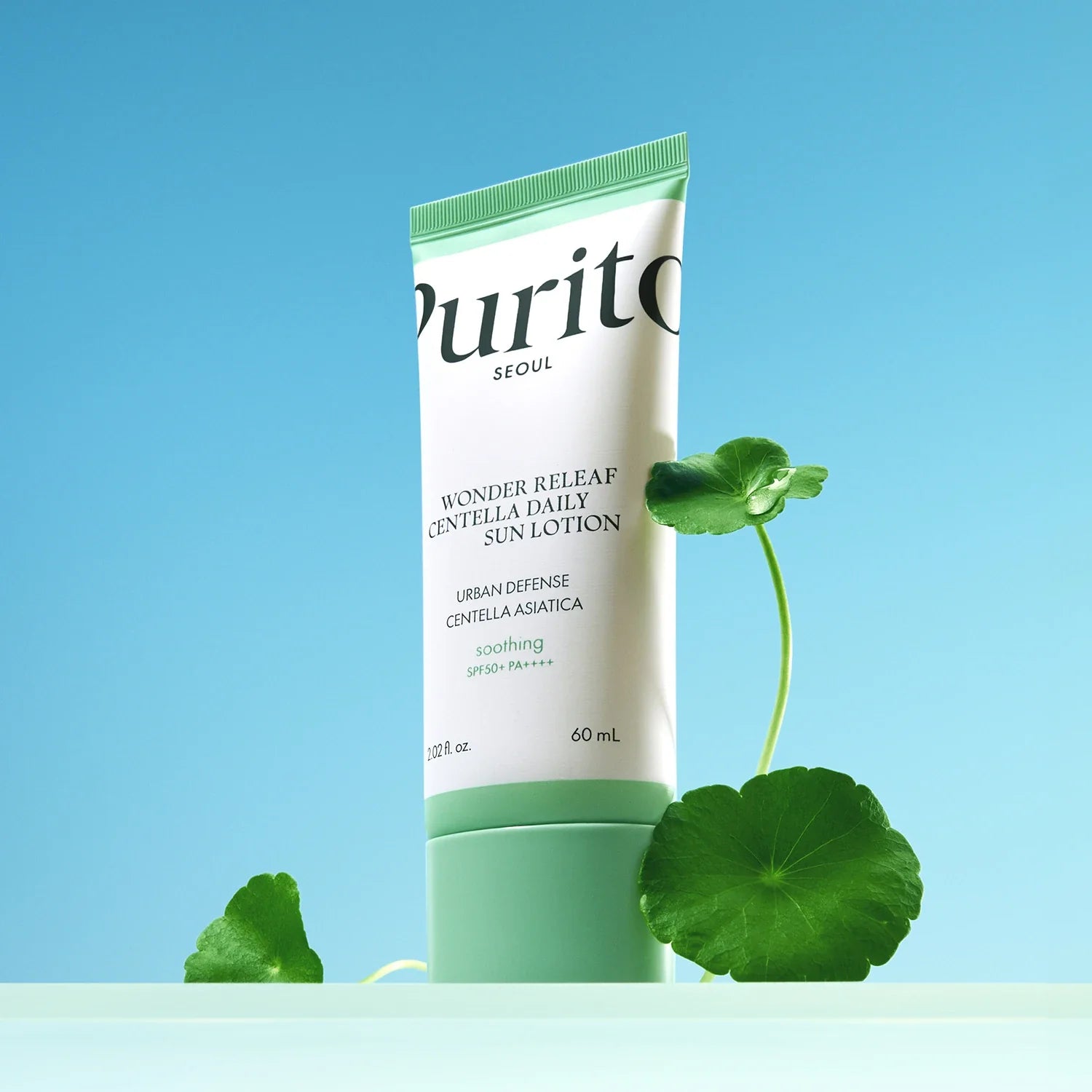 Image of PURITO Wonder Relief Centella Daily Sun Lotion SPF50+PA++++ with Centella Asiatica leaves on a blue background.