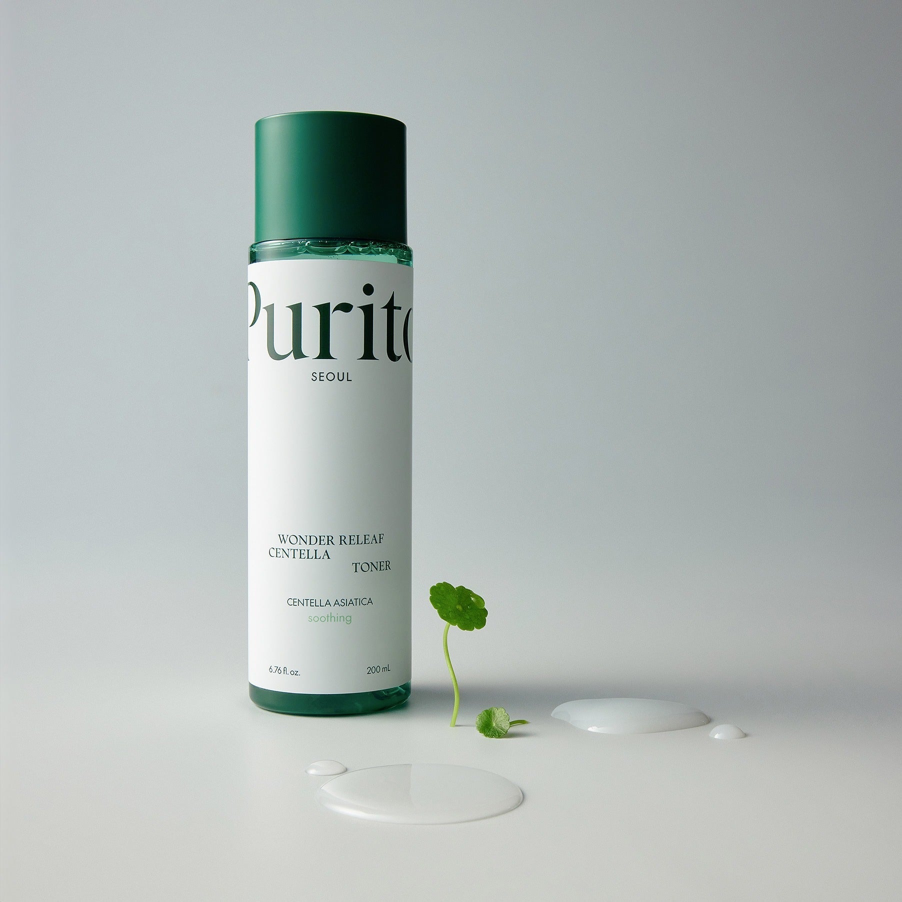 Bottle of PURITO Wonder Relief Centella Toner 200ml with plant and liquid on white background.