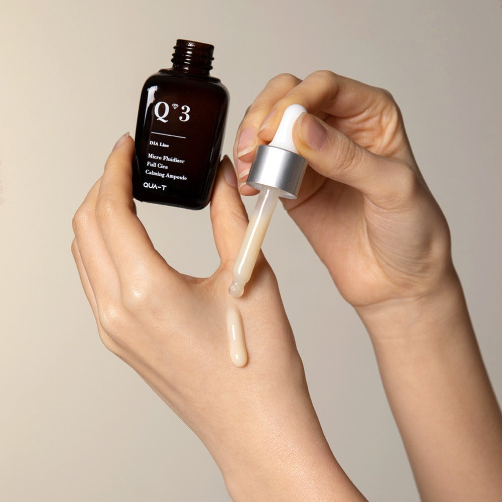 Applying QUA-T Dia Nano Emulsion Full Cica Soothing Ampoule 30ml to skin with dropper.