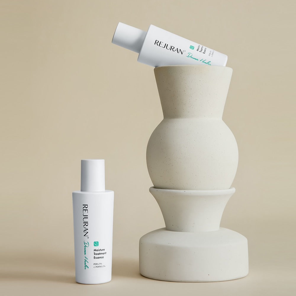 REJURAN Derma Healer Moisture Treatment Essence 70g bottles displayed next to modern vase