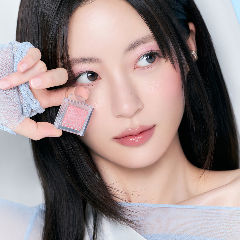 Woman showcasing ROMAND Slide In Single makeup product.