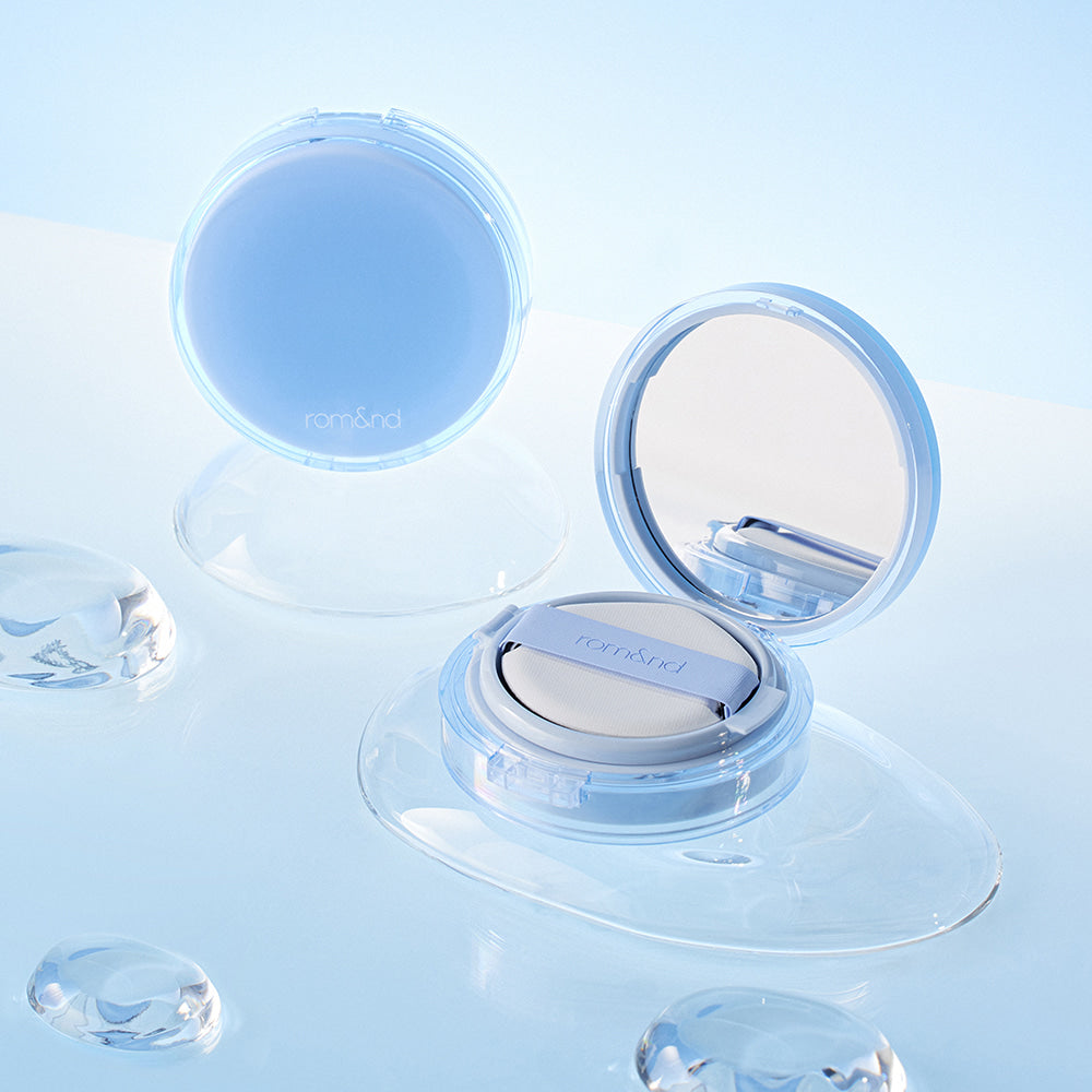 ROMAND bare water cushion displayed with open compact and water droplets on a light blue background