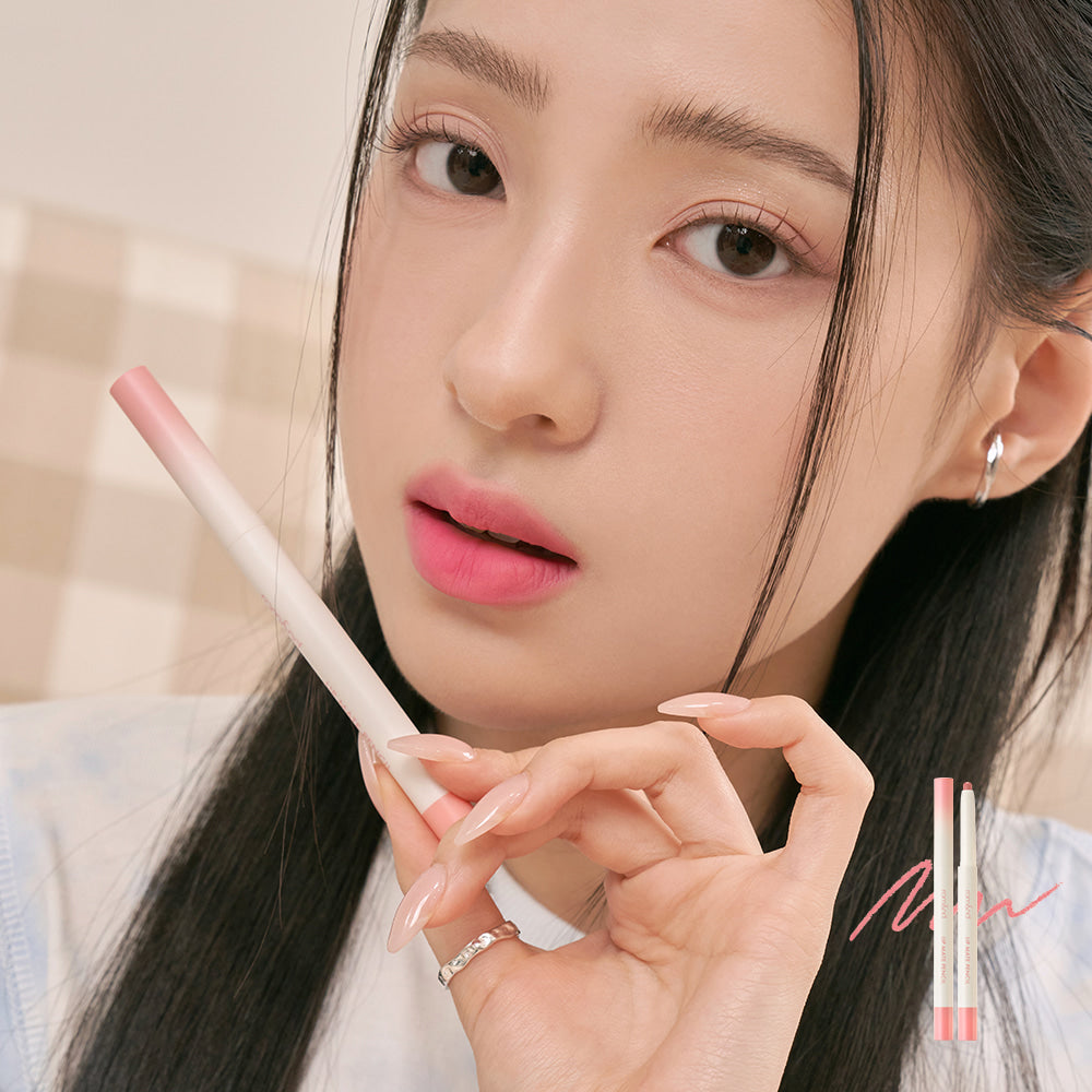 Model holding ROMAND lip mate pencil #beovershade in hand, showcasing its application and color payoff.