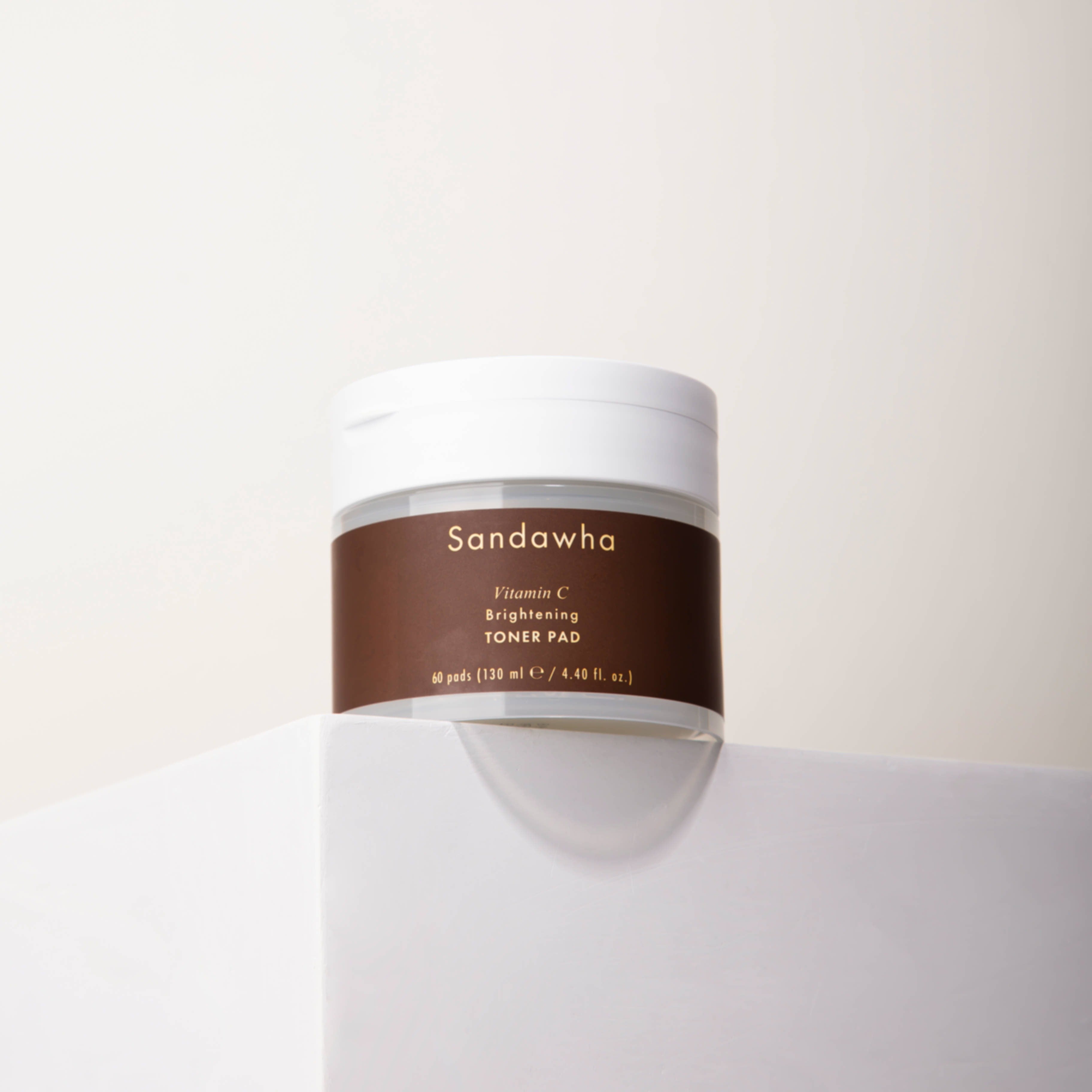 SANDAWHA Vitamin C Whitening Toner pad 60 Sheets in a sleek jar placed on a white surface, skincare product for brightening