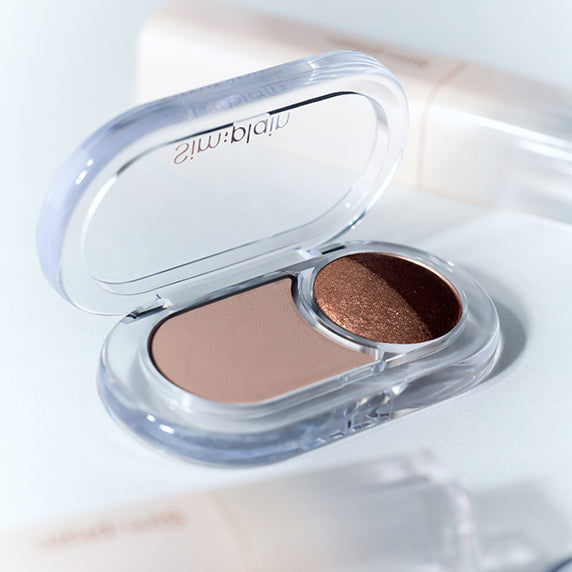 SIM;PLAIN Gleam On Eyes dual eyeshadow compact with shimmer and matte shades, open on a white background.