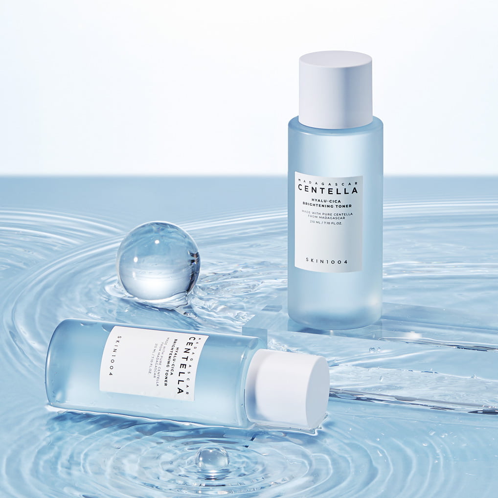SKIN1004 Madagascar Centella Hyalu-Cica Radiance Toner 210ml bottles on a watery surface.