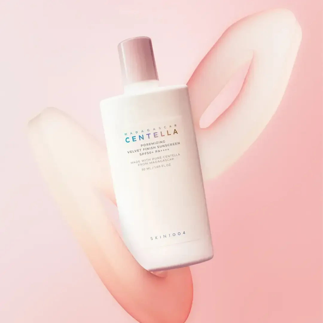 SKIN1004 Madagascar Centella Poreizing Velvet Finish Sunscreen 50ml bottle on a pink background