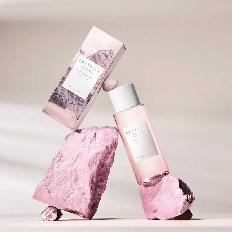 SKIN1004 Madagascar Centella Poremizing Clear Toner 210ml bottle with packaging displayed on pink rocks.