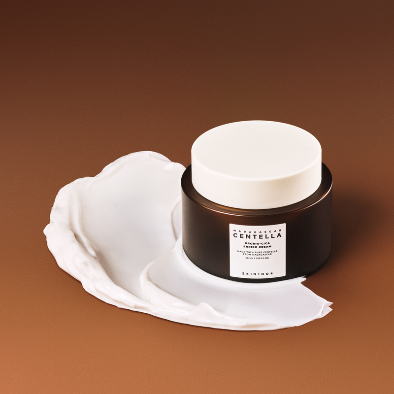 SKIN1004 Madagascar Centella Probio-cica Enrich Cream 50ml on a brown background with cream texture