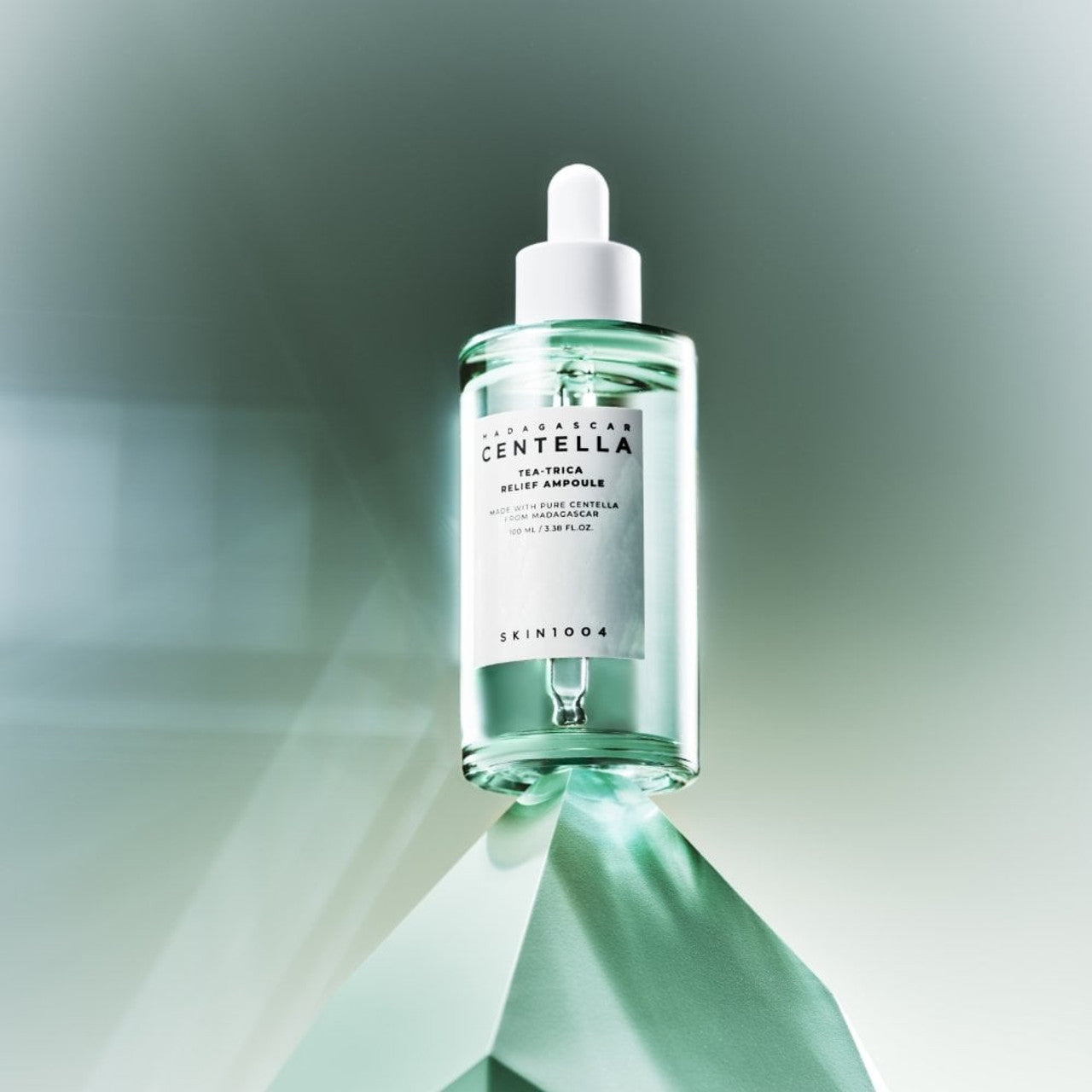 SKIN1004 Madagascar Centella Tea-trica Relief Ampoule 100ml bottle on a green pedestal
