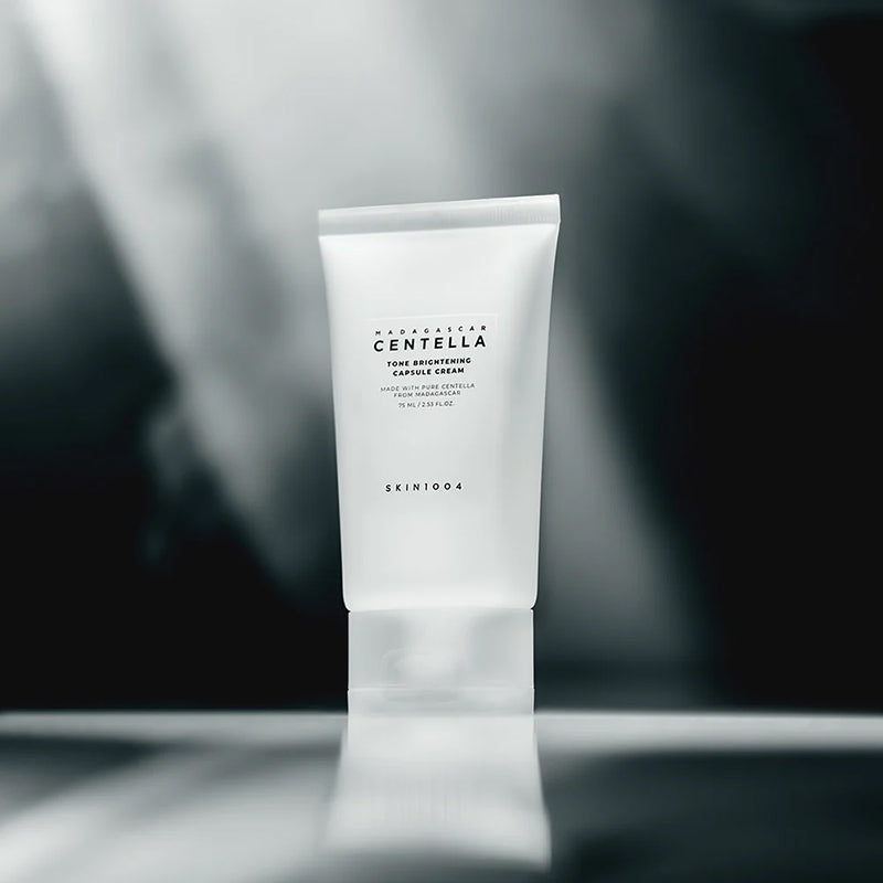 SKIN1004 Madagascar Centella Tone Brightening Capsule Cream 75ml in elegant packaging on blurred background