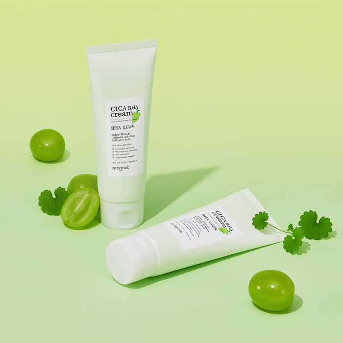 SKINFOOD Shine Muscat Cica Baja Cream 70ml displayed with green muscat grapes and leaves in a bright setting.