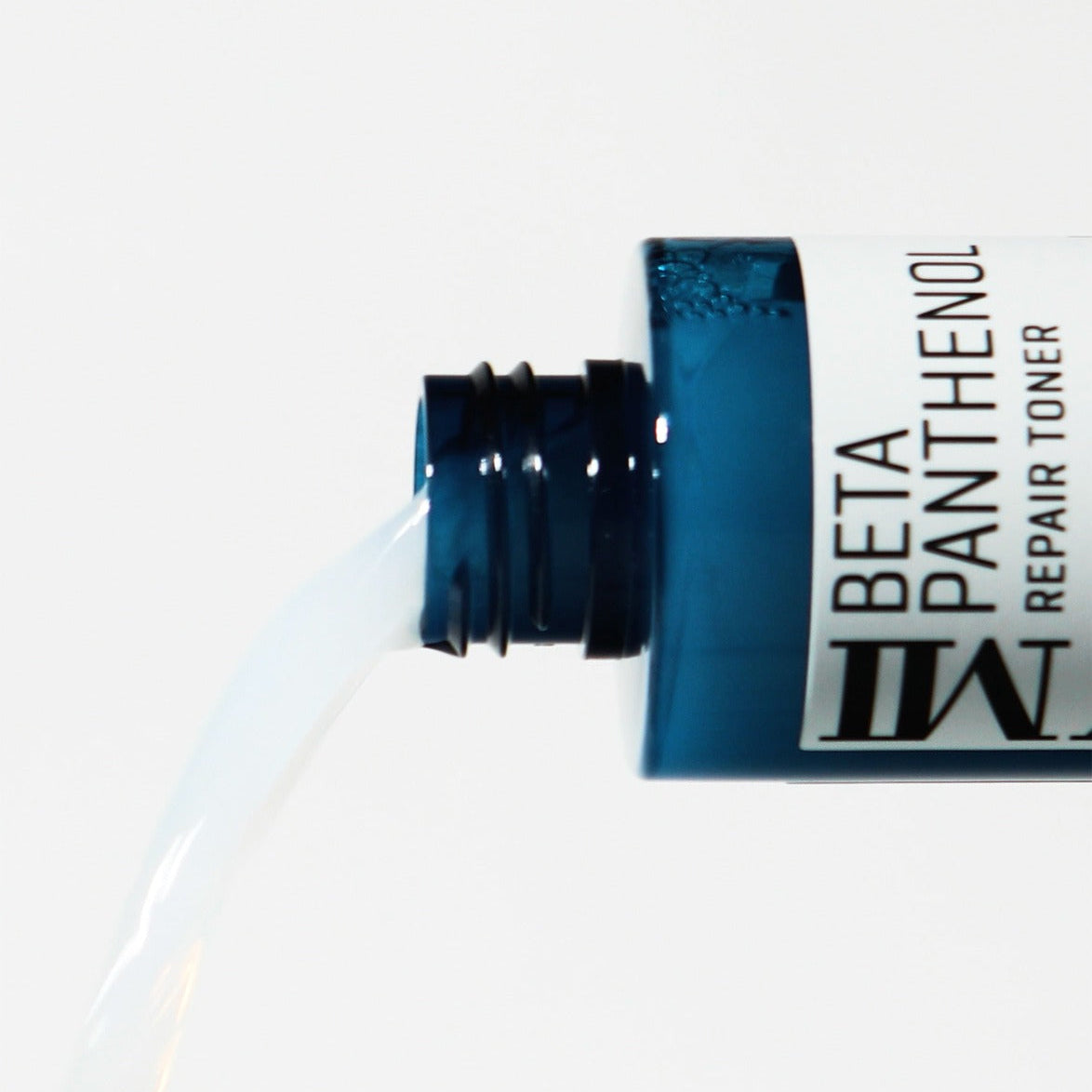 SOME BY MI Beta Panthenol Repair Toner 150ml spilling from blue bottle, close-up of product in action for skincare routine.
