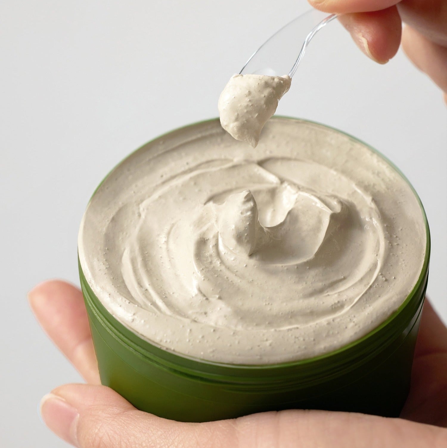 SOME BY MI Super Matcha Pore Clean Clay Mask 100g in jar with a dollop on spatula, showcasing creamy texture for pore care.