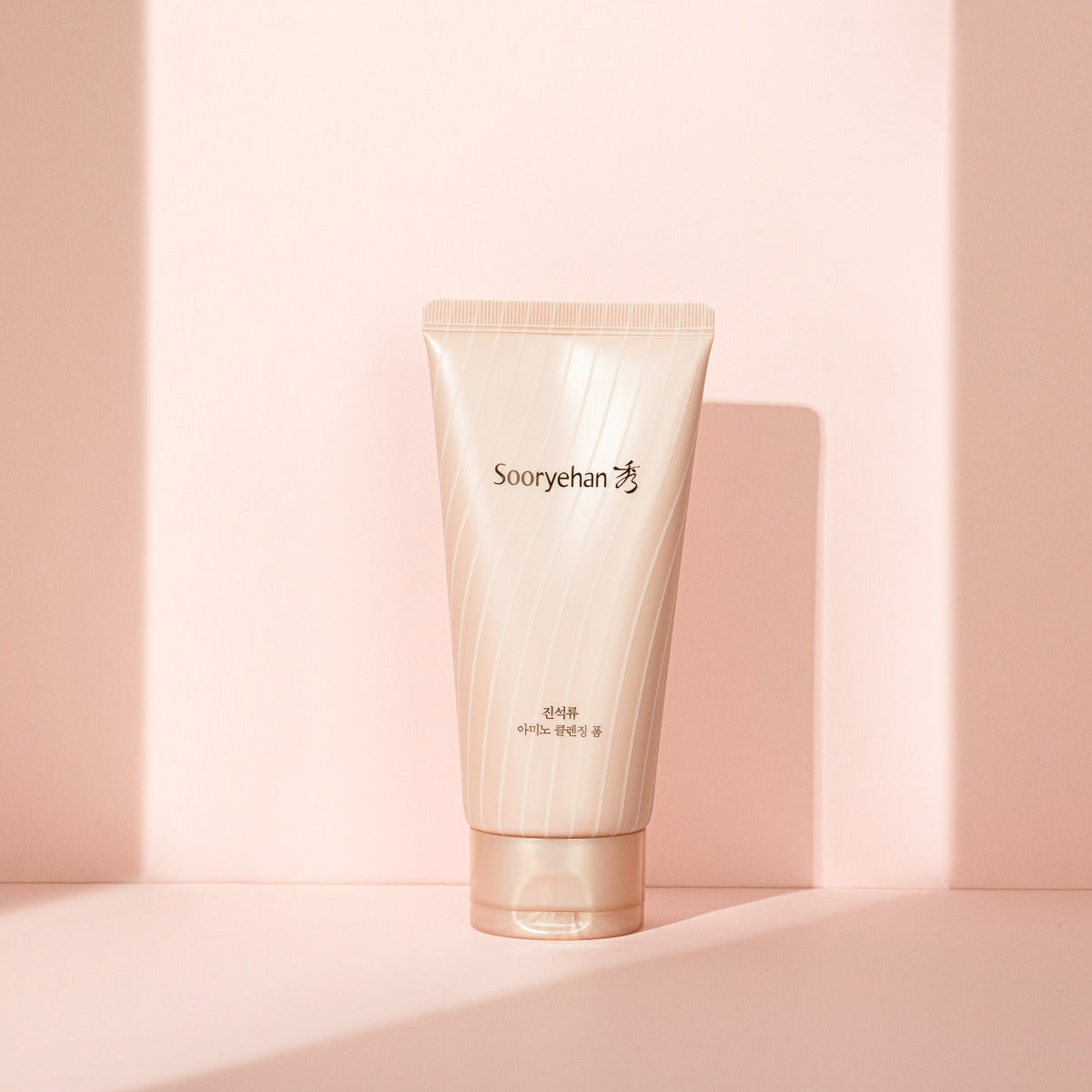 SOORYEHAN Jinseokryu Amino Cleansing Foam 160ml in elegant packaging against a soft pink background