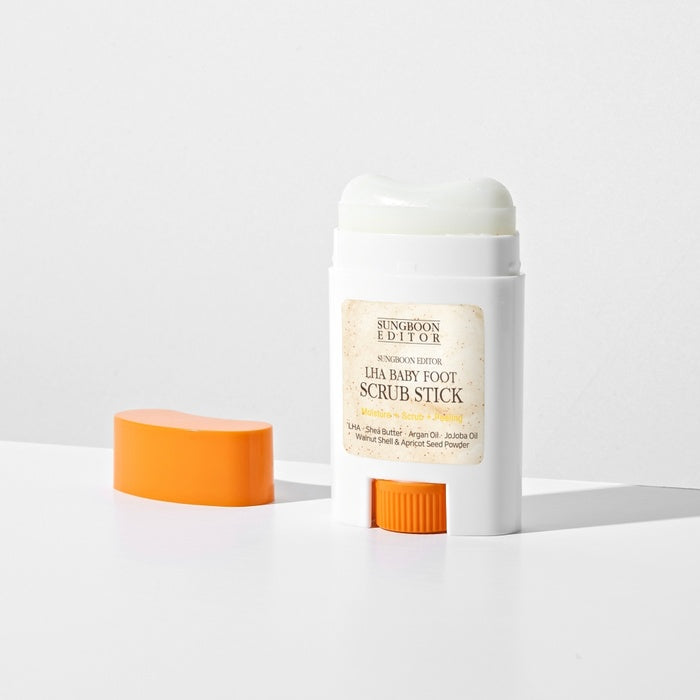 SUNGBOON EDITOR Laha Baby Foot Scrub Stick cylindrical product packaging on white background with orange cap.