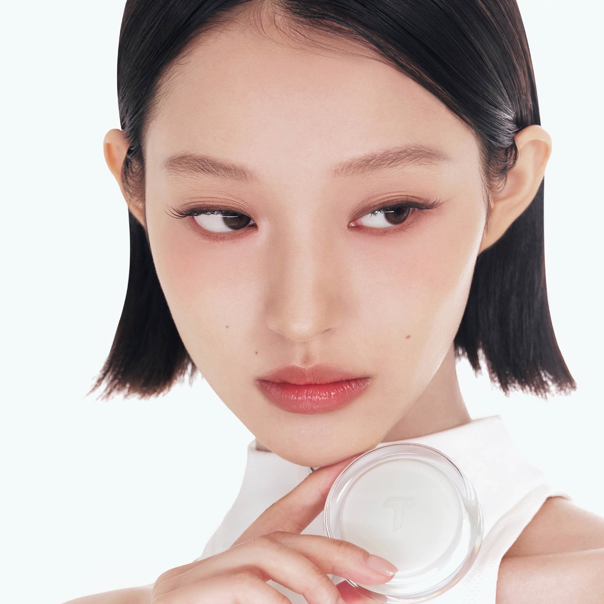 Model holding TENSE Hybrid Makeup Saver, showcasing smooth skin effect