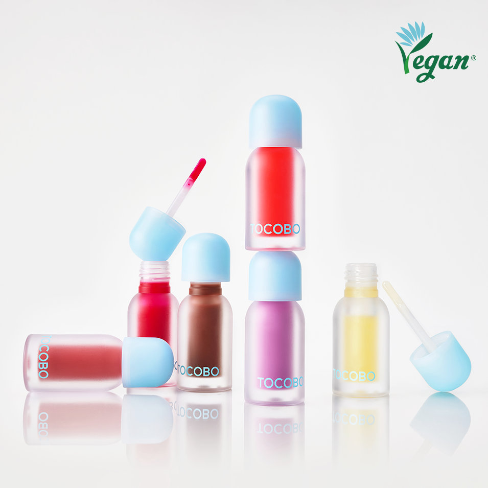 Assorted bottles of TOCOBO Juicy Berry Pluming Lip Oil with a vegan logo on a white background.