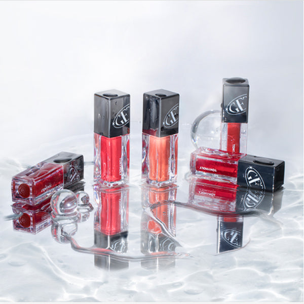 TONY MOLY Get It Tint Colorful Water lip tints displayed on a reflective surface with vibrant shades and sleek packaging.
