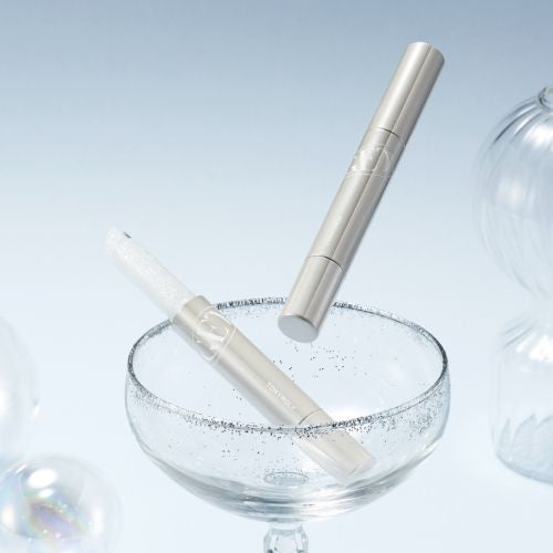 Elegant display of TONY MOLY Get It Tint Glaze Balm in a champagne glass with a light, sophisticated background.