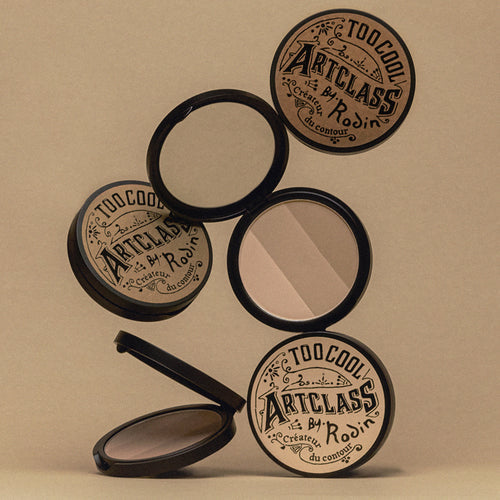 TOO COOL FOR SCHOOL Artclass By Rodin Shading compact powders in open and closed positions on a beige background.