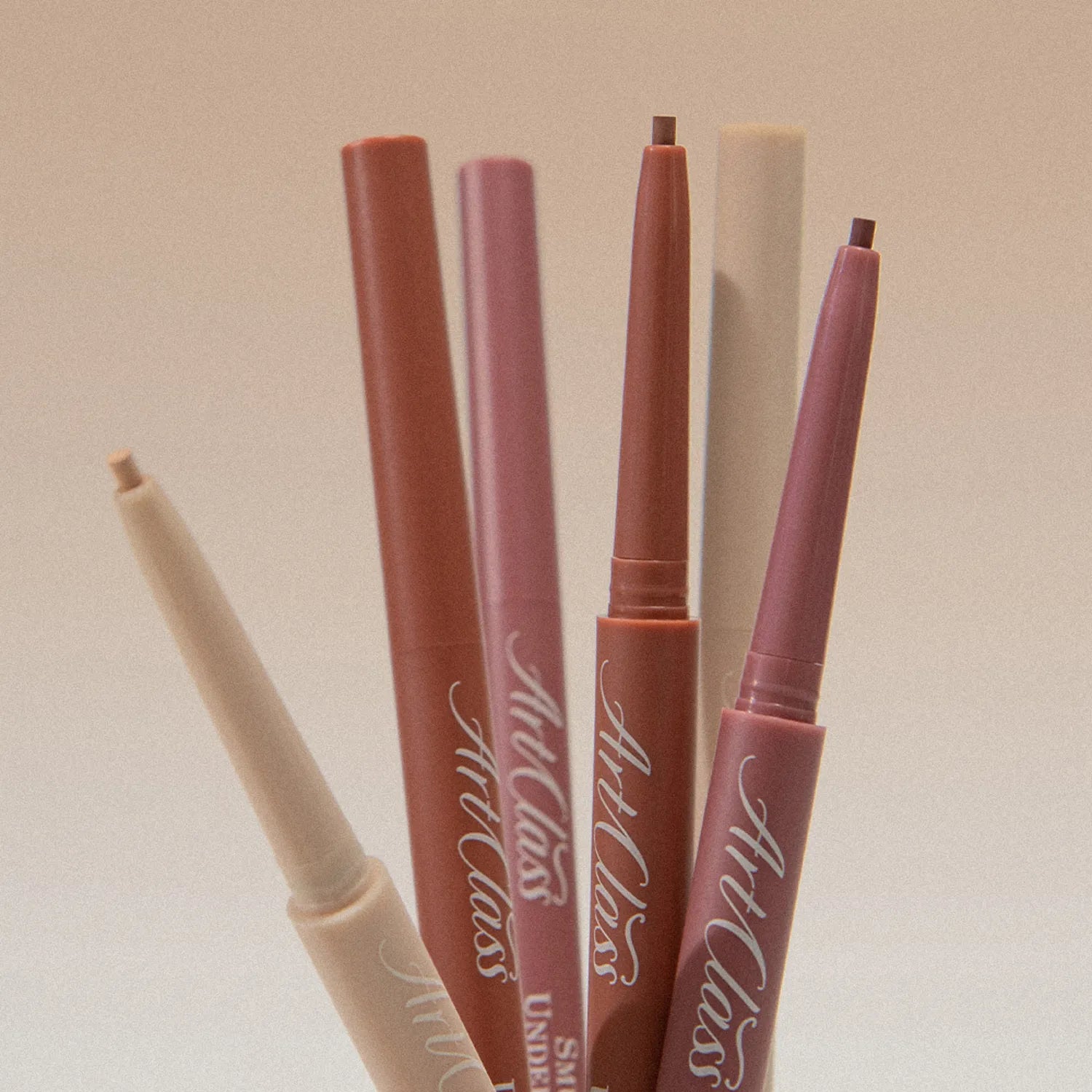 TOO COOL FOR SCHOOL Artclass Smudging Under Liner in various colors, showcasing sleek design and versatile makeup use.