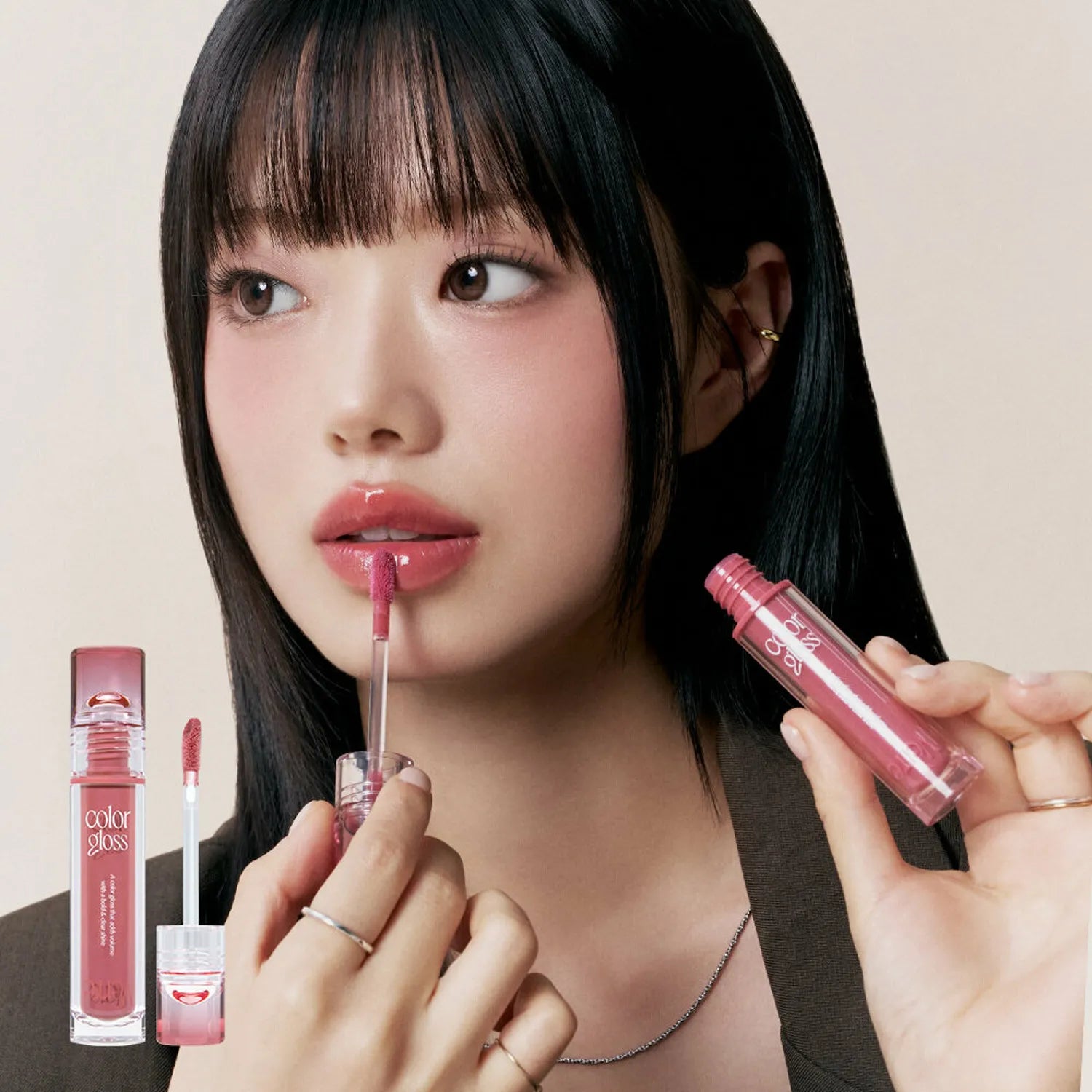Woman applying TOO COOL FOR SCHOOL Verre Color Gloss lipstick, showcasing sleek and glossy lip finish.