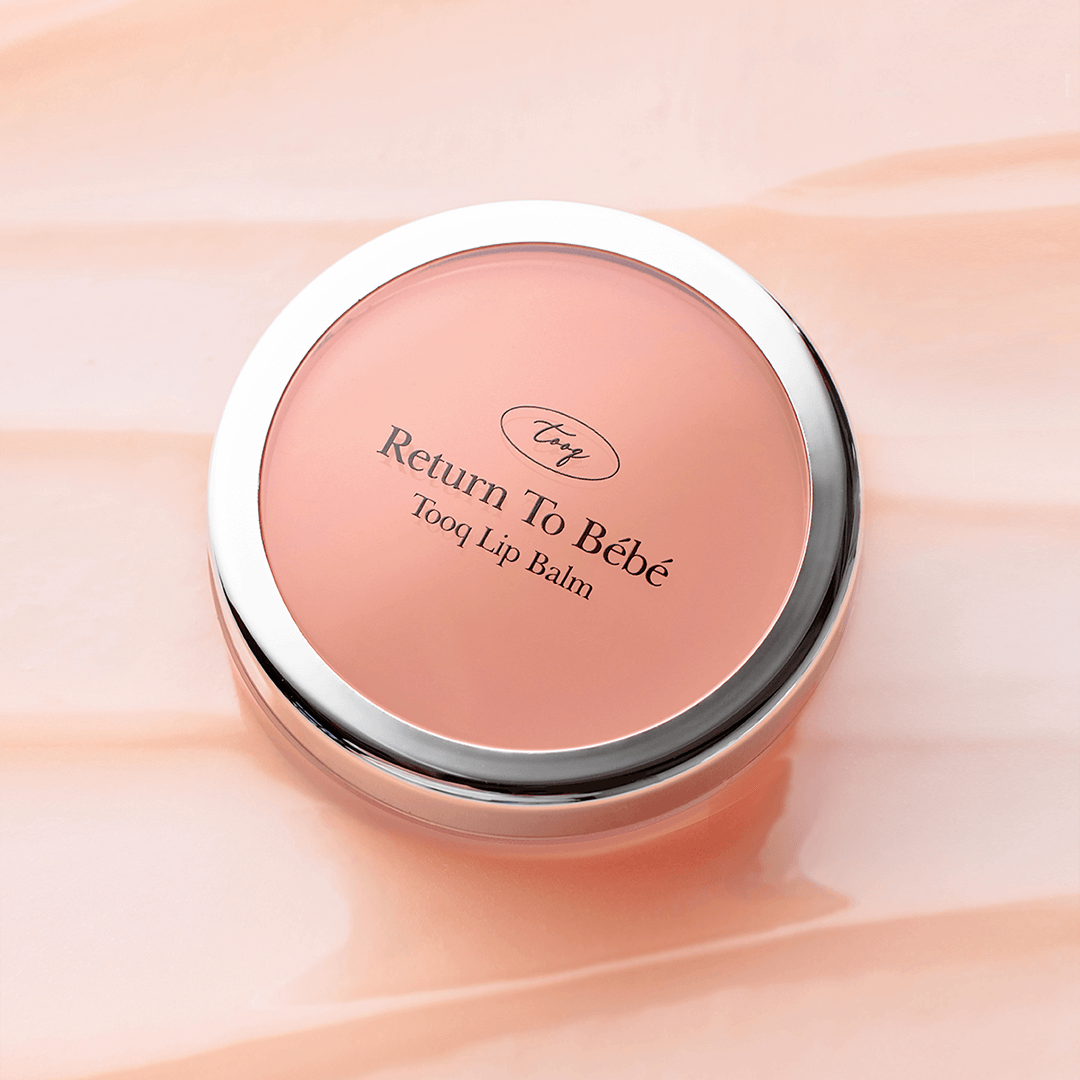 TOOQ Return To Bèbè Lip Balm in round container on peach background