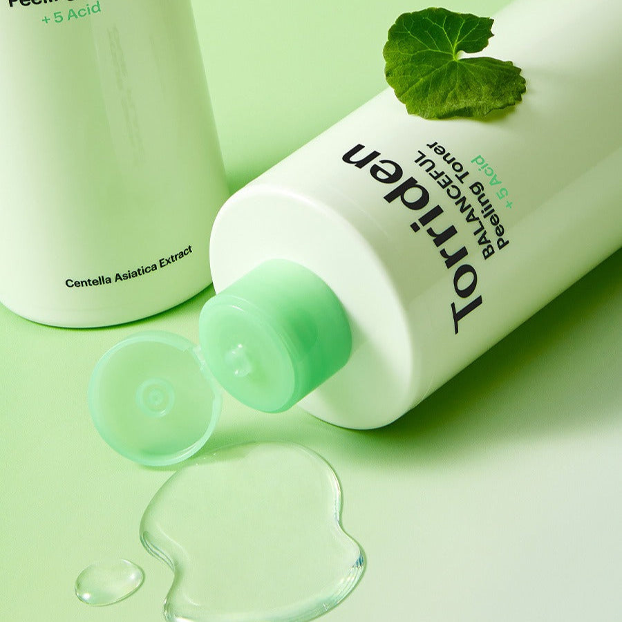 TORRIDEN Balanceful Peeling Toner 250ml bottle with liquid and leaf on green background