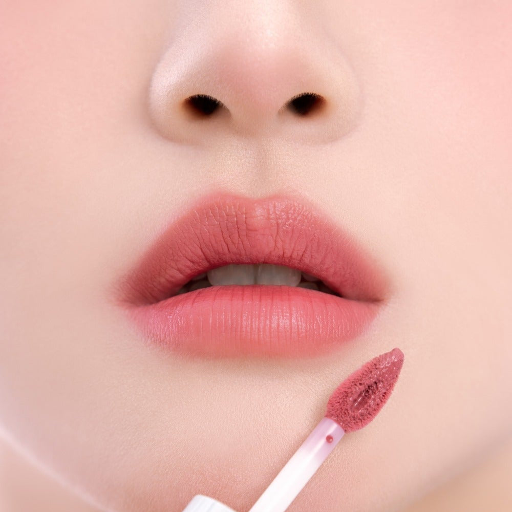 Close-up application of UNLEASHIA Clound Kiss Velvet Tint on lips, showcasing the vibrant color and smooth texture.