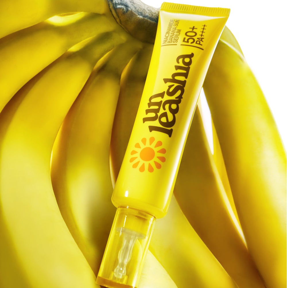 UNLEASHIA Niacinamide Banana Sun Serum 40ml with SPF 50+ displayed on a bright yellow banana background