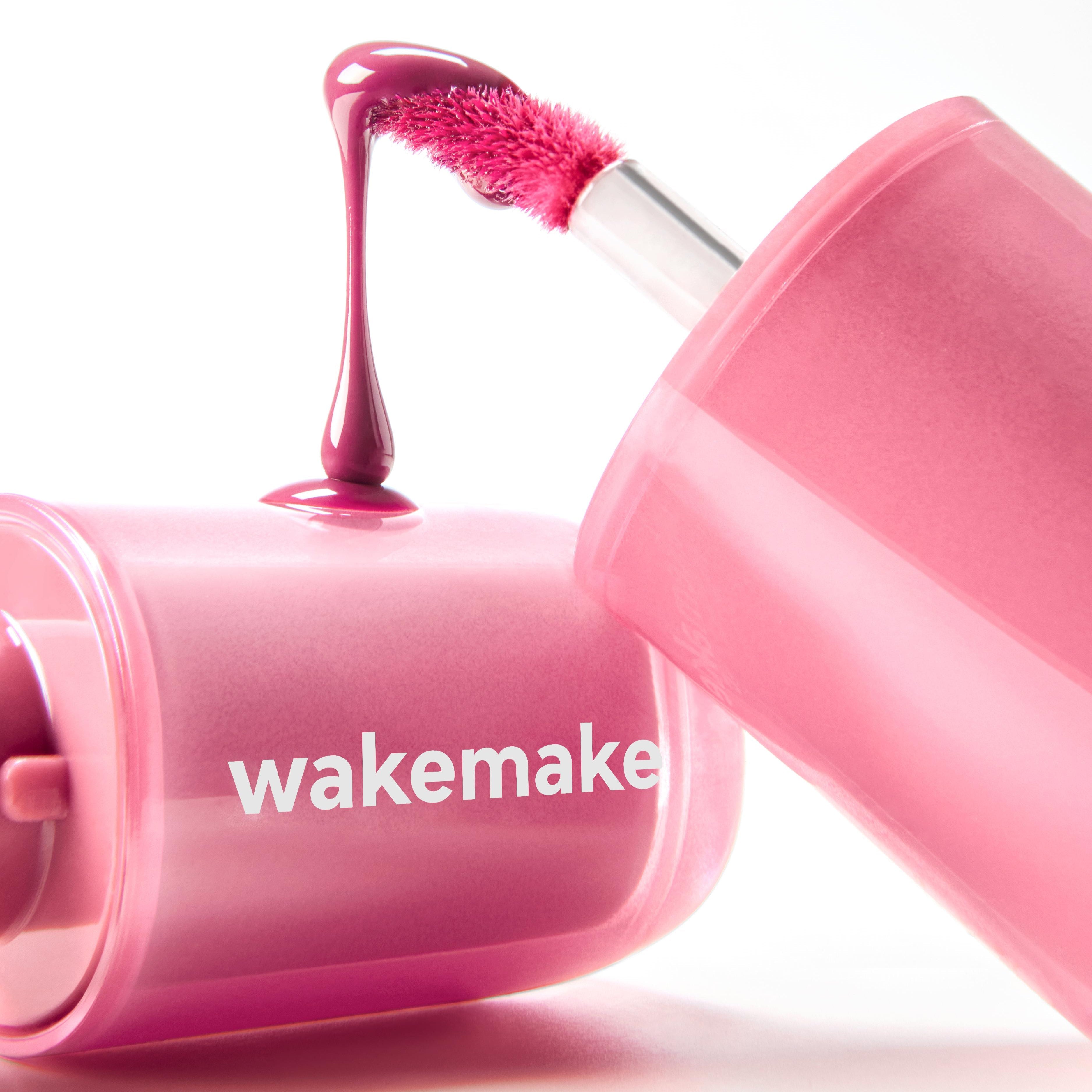 WAKE MAKE Waterfull Glow Tint 4.6g in vibrant pink shade with applicator on display.