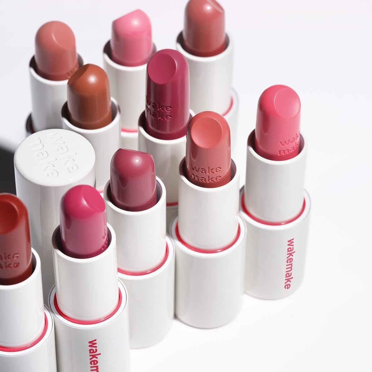 WAKEMAKE Healthy Glow Balm Sticks in various colors arranged in a row, showcasing luxurious moisturizing lip care.