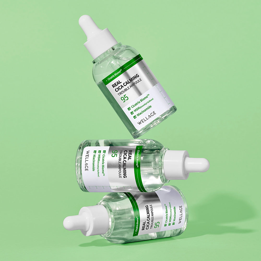 WELLAGE Real Cica Calming 95 Trouble Ampoule 50ml skincare product bottles on a green background