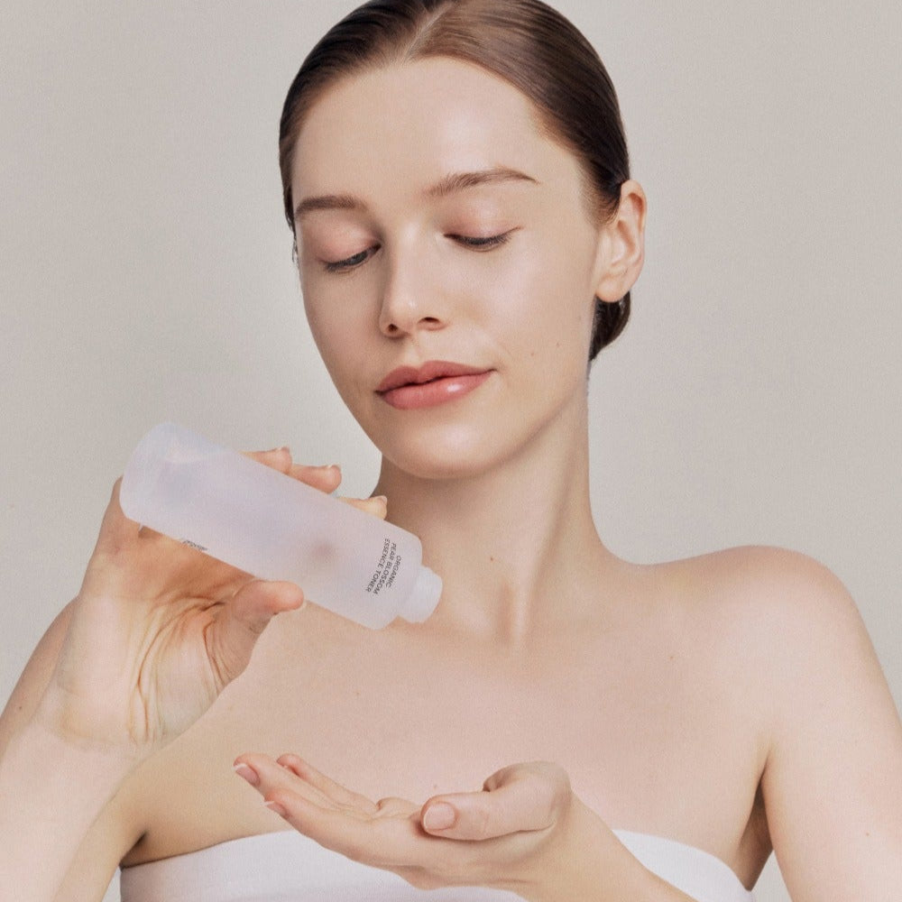 Model applying WHAMISA Organic Pear Blossom Fermented Essence Toner 160ml to hand