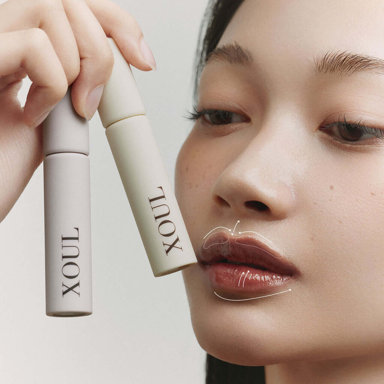 Woman applying XOUL Lip Line Tattoo for enhanced lip definition with XOUL products showcased.