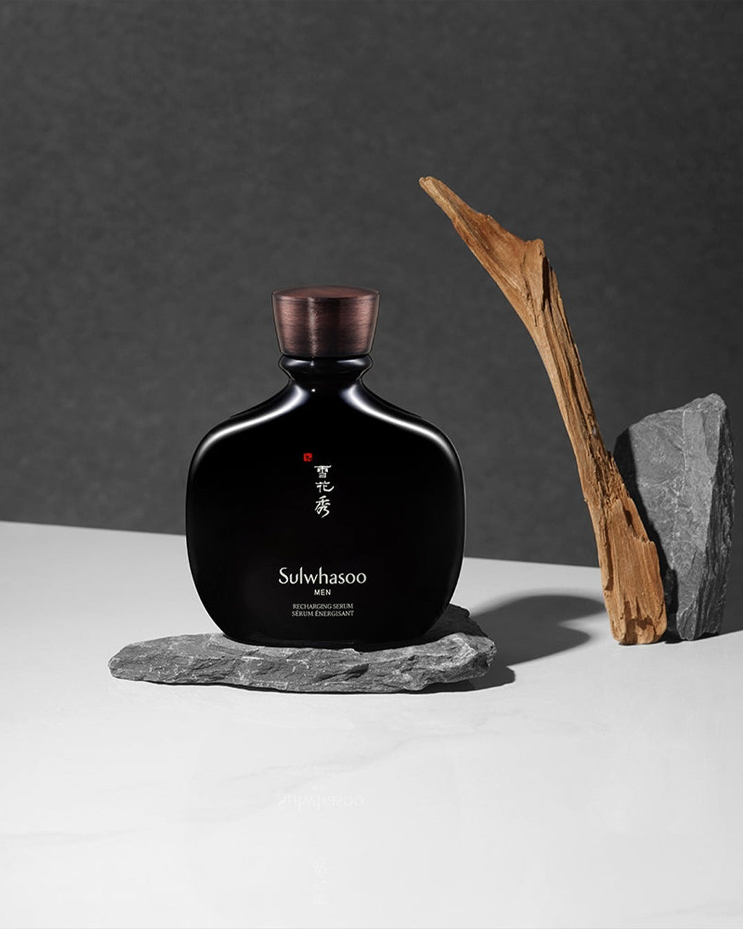 Luxury Sulwhasoo skincare bottle on a minimalist rock and driftwood setting