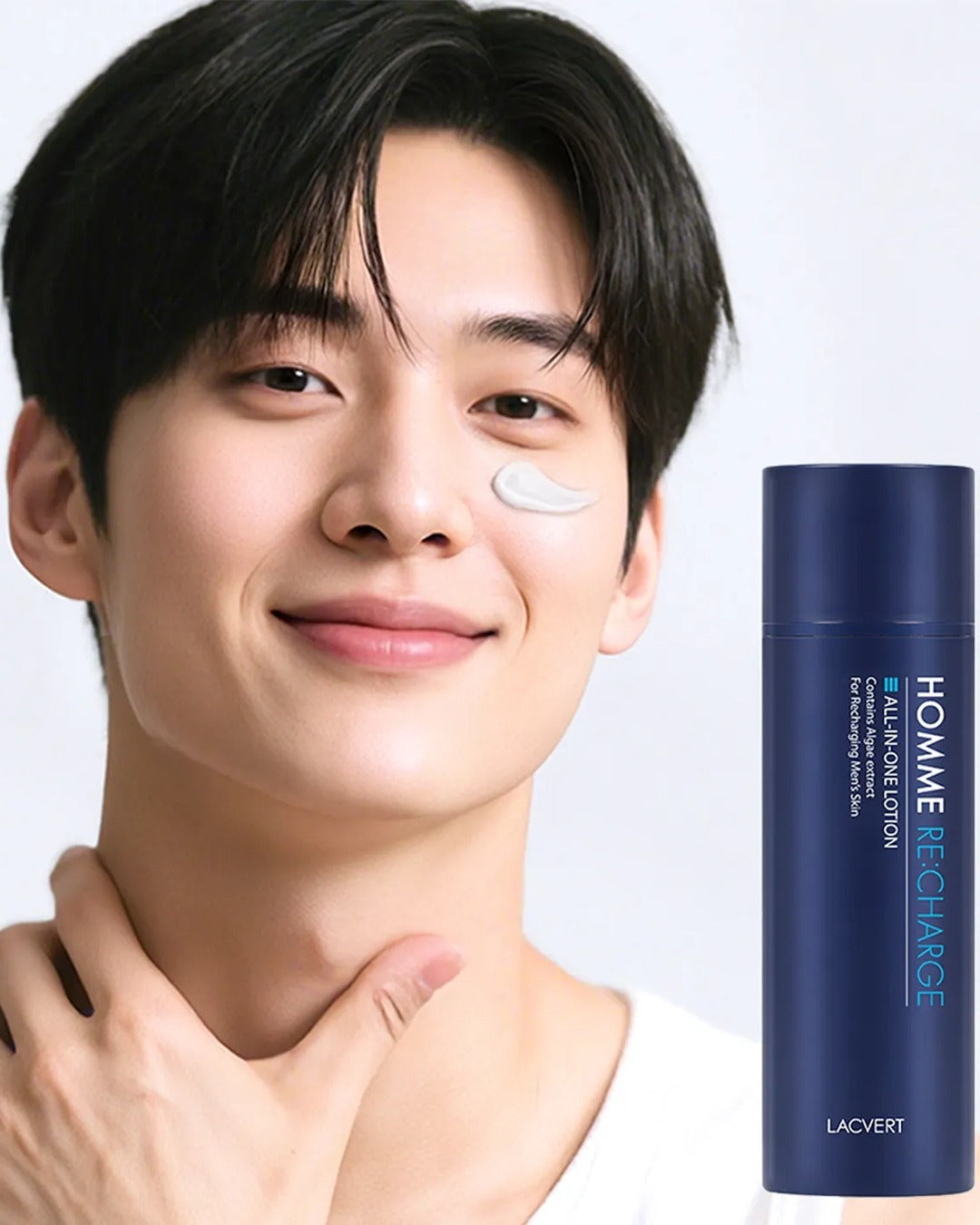 Man smiling while applying Homme Recharge Balance Lotion to his cheek, showcasing skincare routine with lacvert product.