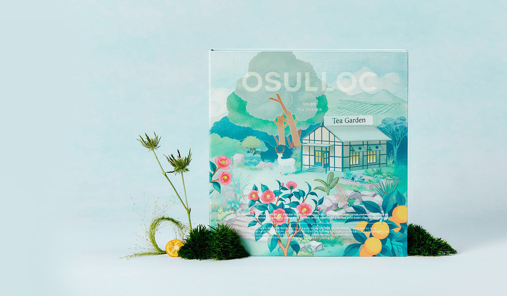 OSULLOC Tea Garden packaging design featuring vibrant illustration of a garden with trees, flowers, and a house on a light background.