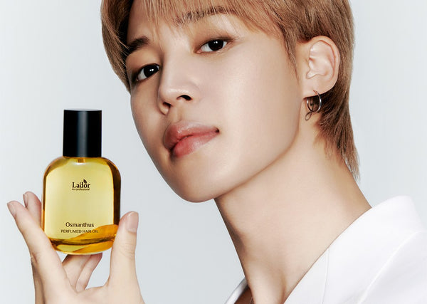 Model showcasing a bottle of Osmanthus perfume hair oil, representing the focus of 🌿 The Ultimate Guide to Korean Haircare: Secrets to Healthy, Glossy Hair.