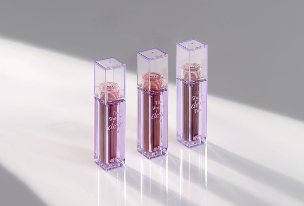 Elevate Your Makeup Game with MERZY's Innovative Products: Trio of sleek, purple-cased lipsticks in elegant minimal lighting