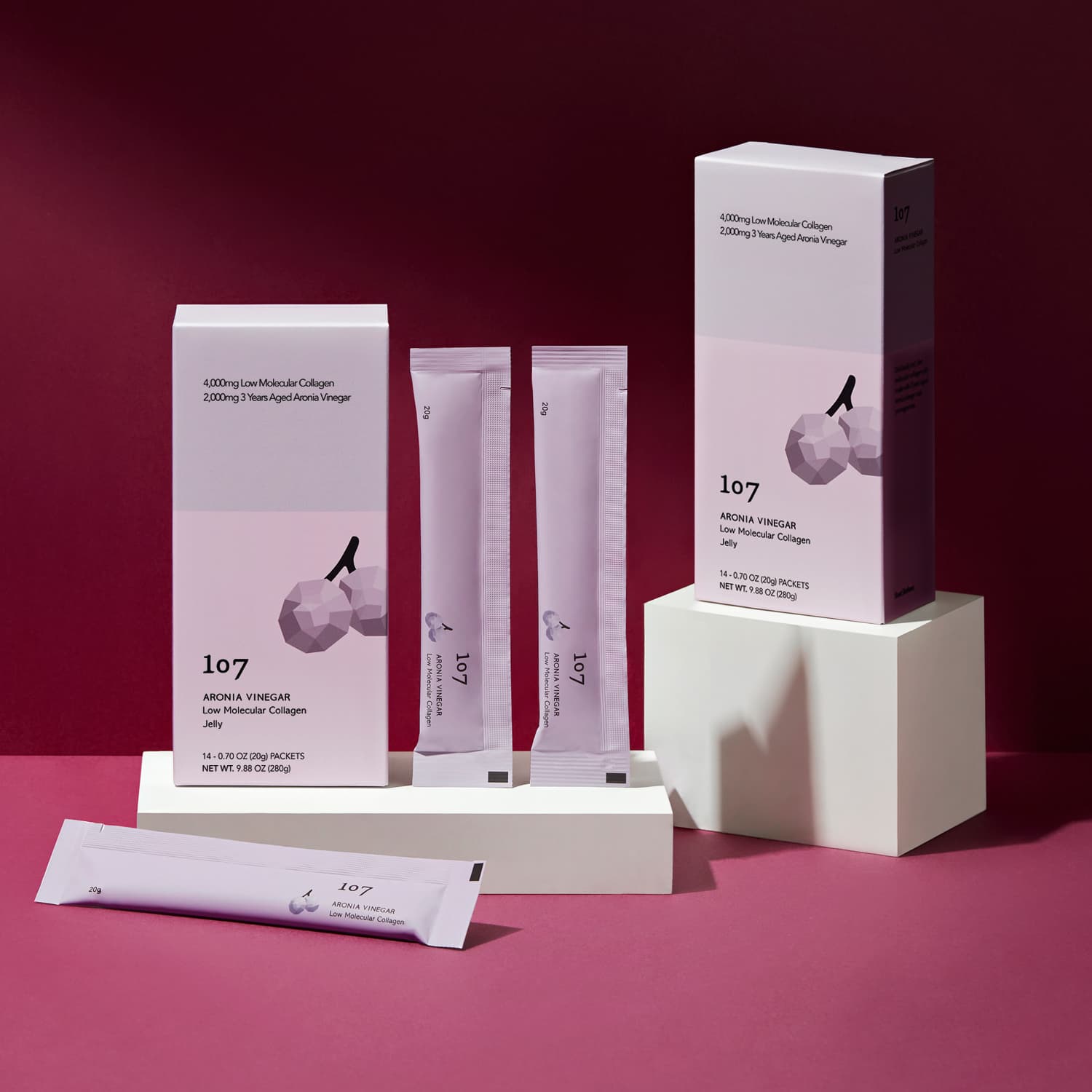 107 Aronia Vinegar Low Molecular Collagen 20g x 14 Packets displayed in elegant packaging on a rich burgundy background.