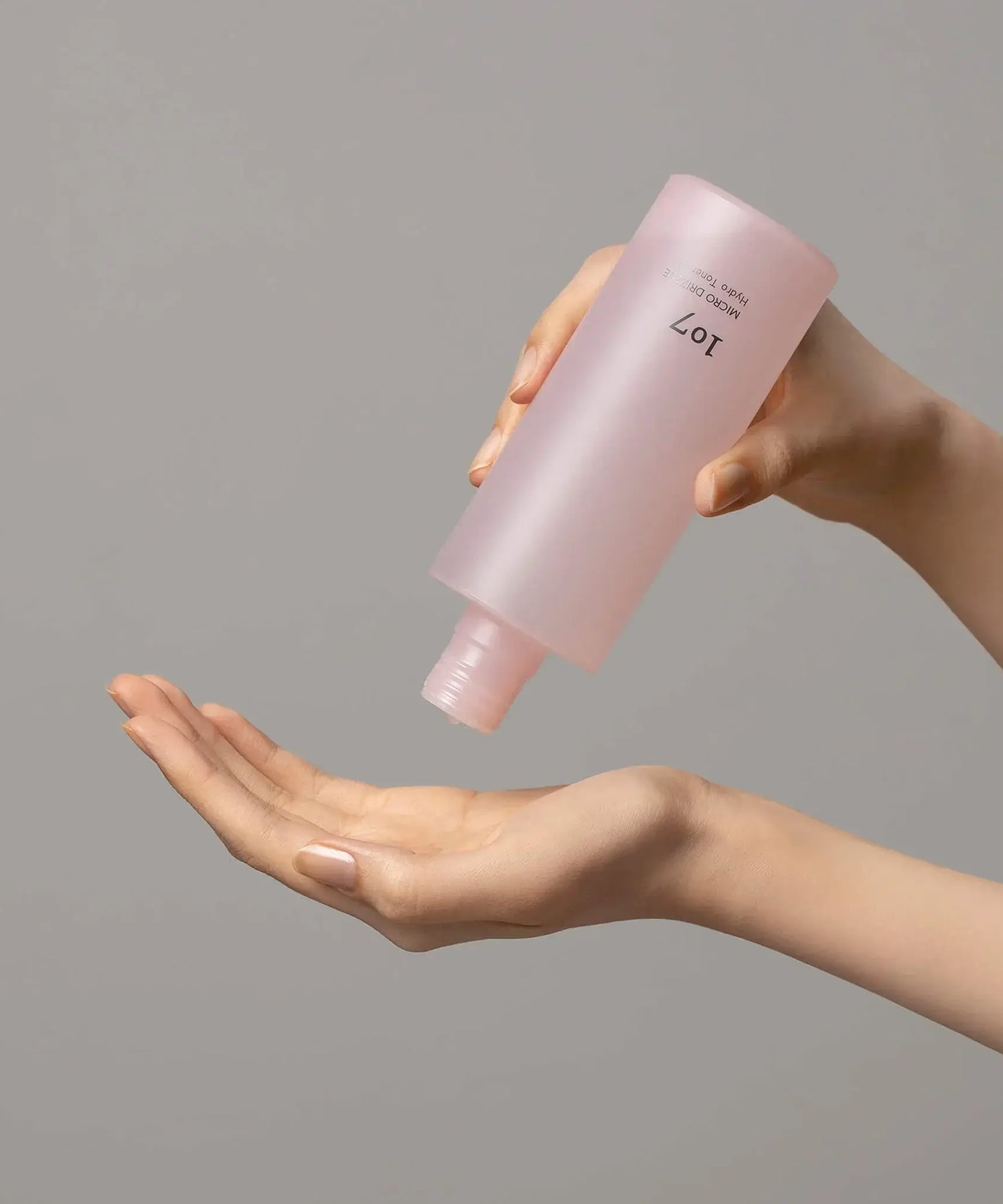 107 Micro Drizzle Hydro Toner 155ml being poured onto hand for skincare routine