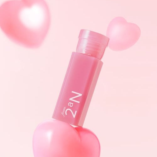 2an Mini Glaze Bouncing Tint on a pink background with heart accents